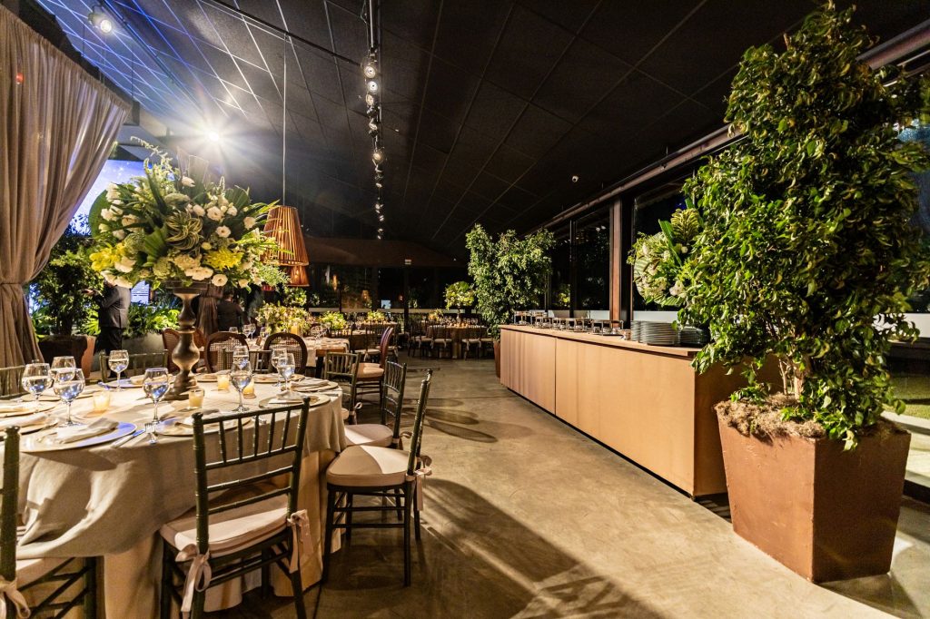 Chic indoor dining area with floral arrangements, elegant table settings, and warm lighting. — A Southwestern Loft Decor