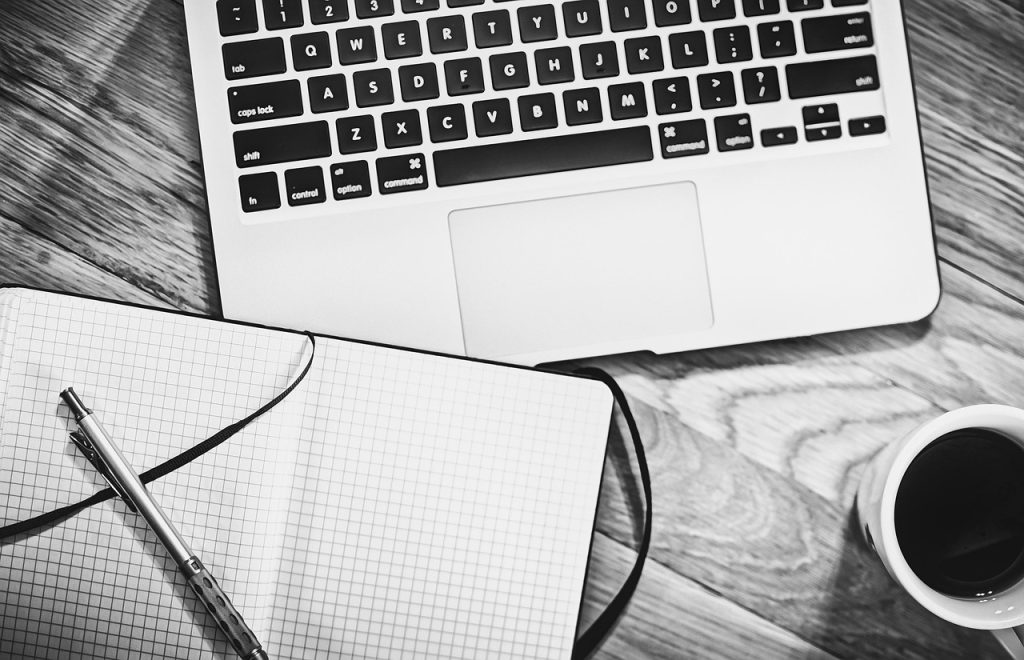 Computer, notebook, coffee — Common Misconceptions About Renters Insurance in Ohio