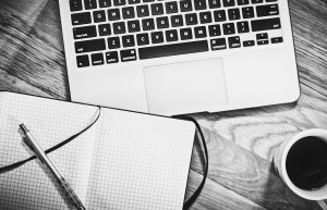 Computer, notebook, coffee — Common Misconceptions About Renters Insurance in Ohio