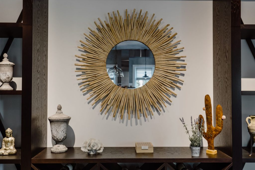 Contemporary living room featuring a unique sunburst mirror and chic decor accents. — Easy Beach Decor Projects