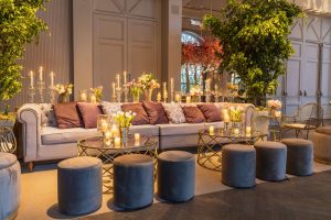 Cozy and stylish indoor lounge featuring plush seating, floral arrangements, and candlelit ambiance. — How to take care of wo