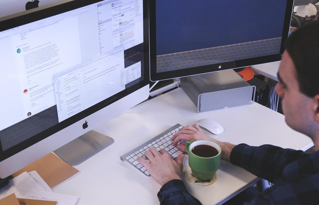 Typing, computer, man — The Game-Changers: Benefits of Partnering with Top SEO Firms in NY