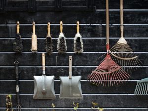 Neatly arranged garden tools hanging on a rustic wooden wall. — Using Pavestones inside your Landscaping to produce a Decorat